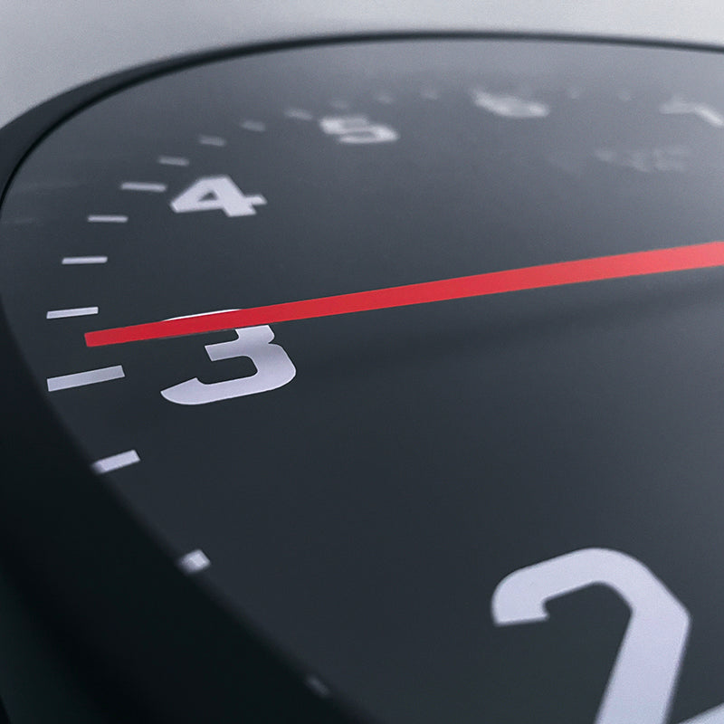 Tacho Wall Clock Close Up. Timekeeping redesigned in the style of a sports car rev counter. Only available from FiveTo.co.uk