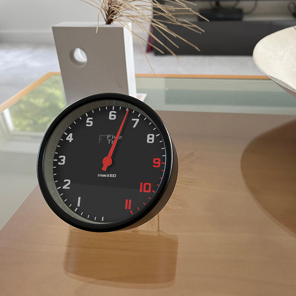 FiveTo Tacho desk clock on coffee table. Timekeeping redesigned in the style of a sports car rev counter. Exclusively from www.Fiveto.co.uk