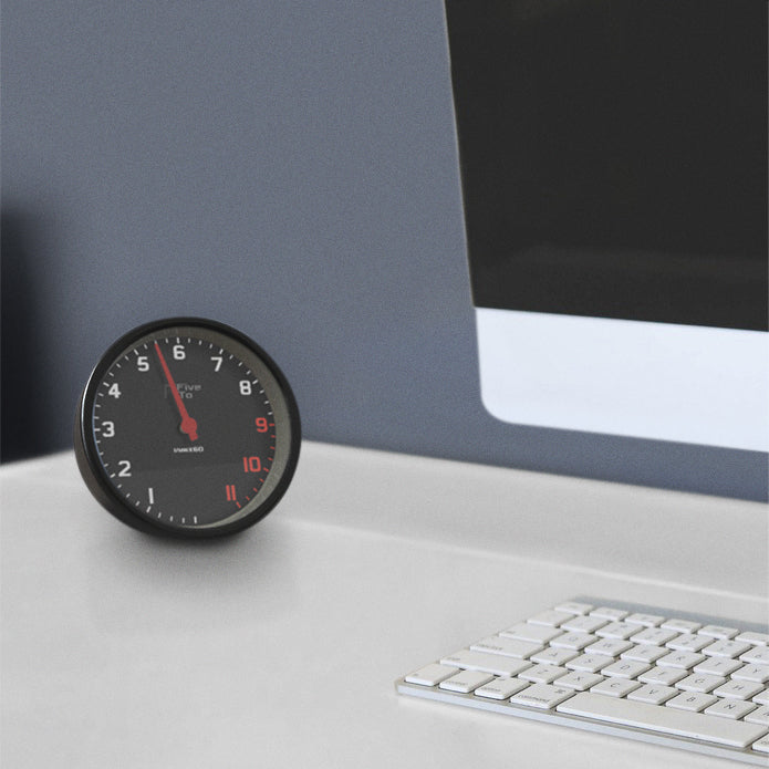 FiveTo Tacho desk clock office scene, timekeeping redesigned in the style of a sports car rev counter. Only available from Fiveto.co.uk