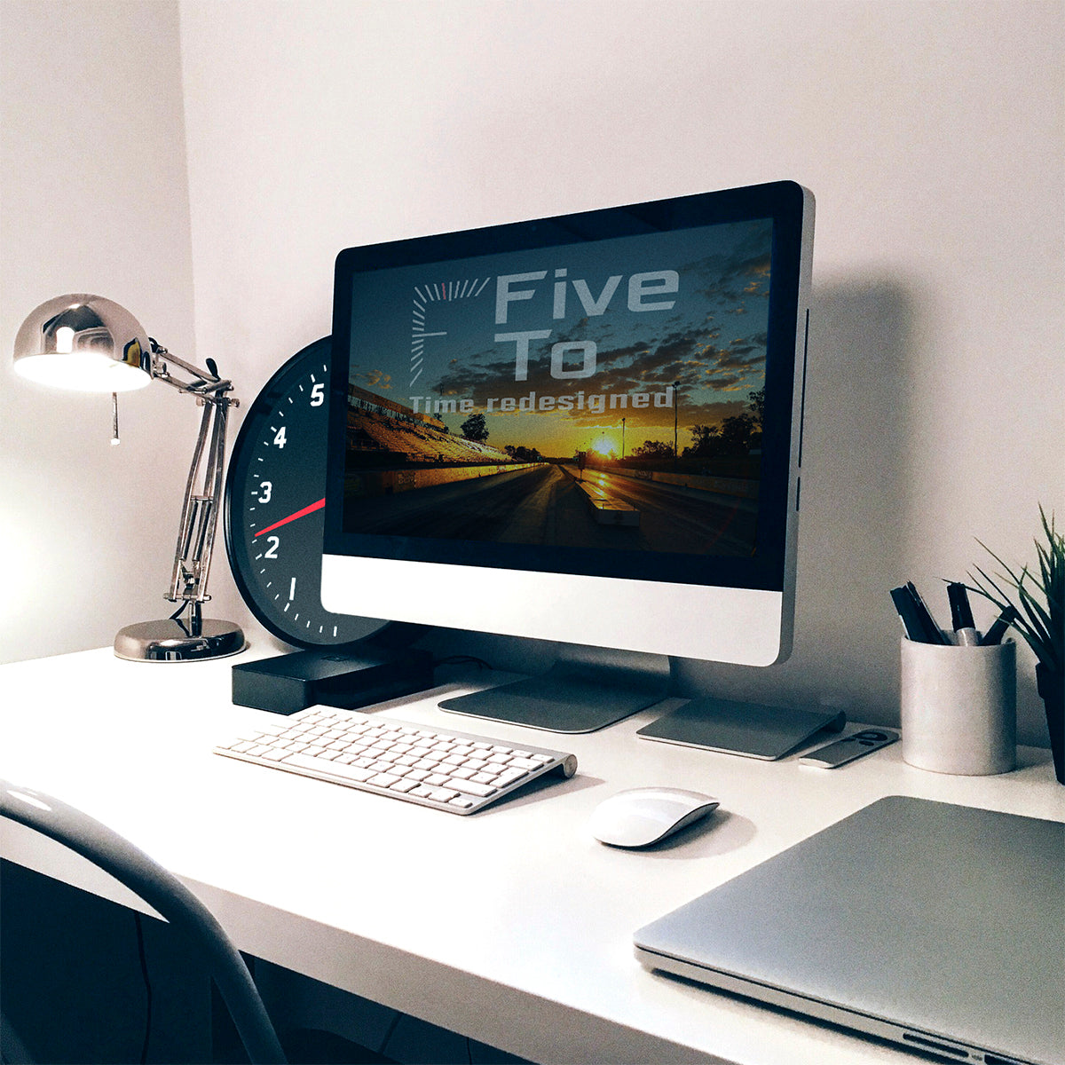 The Time is 2.20 Tacho Wall Clock behind computer screen,exclusively available from www.FiveTo.co.uk